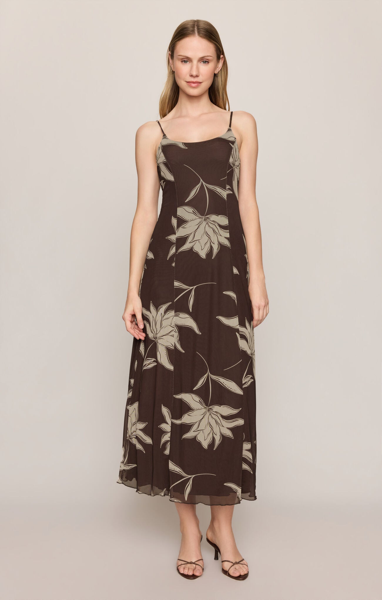 Woman wearing a Dark Chocolate Charisma Floral Midi Dress by z supply with thin straps and floral print design
