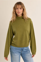 Molly Bracken Lime Green Sweater worn by a model with jeans