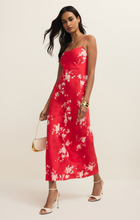 Woman wearing Kiss Me Red Alyse Darya Floral Maxi Dress by z supply with spaghetti straps and white heels
