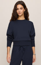 Woman wearing a navy blue Eclipse Comеback Sweatshirt by z supply with long sleeves and a relaxed fit