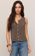 Woman wearing a brown Pebble Coast Syd Sweater Vest by z supply styled with blue jeans and a wooden bangle bracelet