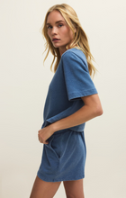 Woman wearing Calypso Blue Indigo Curran Knit Denim Sweatshirt by z supply in soft indigo knit fabric side view
