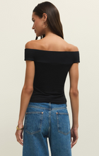 Woman wearing a sleek black second skin off shoulder top by z supply paired with blue denim jeans, back view