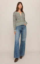 Woman wearing Aqua Cloud Medina Stripe Cardigan by z supply paired with wide-leg jeans and brown boots.