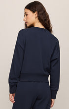 Woman wearing navy blue Eclipse Comеback Sweatshirt by z supply, shown from back with long sleeves and ribbed hem