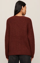 Woman wearing a deep red knit Velvet Rouge Whitmore Cardigan by z supply, shown from the back with black jeans