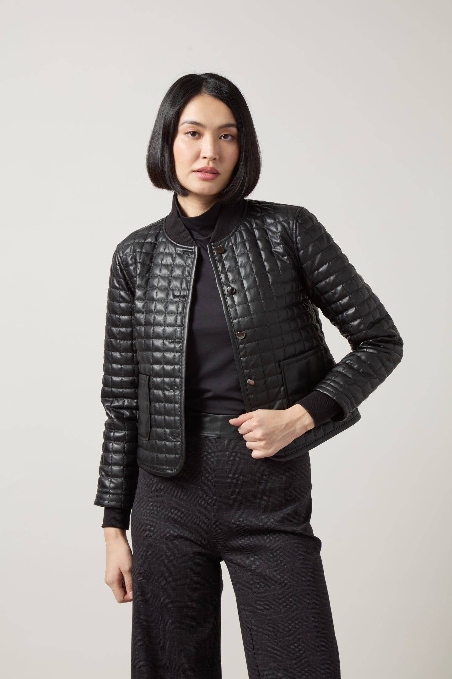 Black Agnes Quilted Vegan Leather Jacket by Lysse modeled by a woman in black outfit