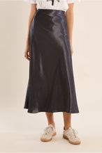 Gun Metal Skirt by Molly Bracken in a glossy midi silhouette styled with white sneakers