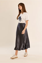 Molly Bracken Gun Metal Skirt in a flowing metallic midi style worn with a graphic tee and sneakers