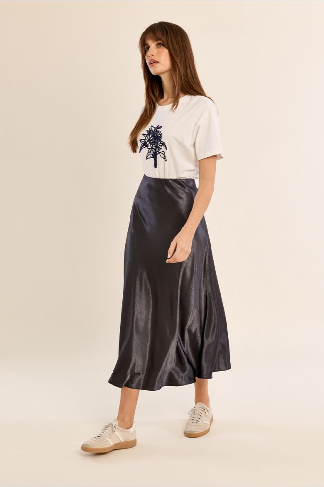 Molly Bracken Gun Metal Skirt in a flowing metallic midi style worn with a graphic tee and sneakers