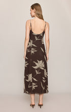 Woman wearing Dark Chocolate Charisma Floral Midi Dress by z supply with thin straps and beige floral print, viewed from back