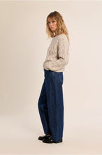 Molly Bracken Off White Cable Sweater modeled with wide leg jeans