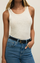 Woman wearing Cloud Classic Slub Scoop Tank by z supply in soft fabric paired with high-waist jeans and black belt