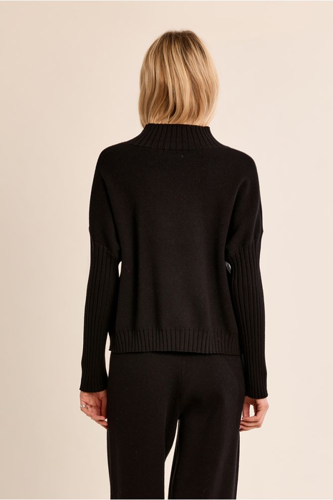 Molly Bracken Black Modern Knit Sweater shown from the back with ribbed collar cuffs and hem