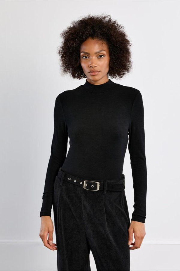 Molly Bracken Whisper Top in black with long sleeves and a high neckline worn by a model