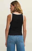 Woman wearing a black Clarke Rib Tank by z supply showing back view with contrast trim and blue denim jeans