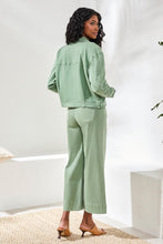 Model seen from behind wearing Tribal Comfort Stretch Denim Button-Front Jacket in muted green paired with matching wide-leg pants