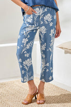 Front view of Tribal Denim Printed Wide Leg Crop Pant with white floral print styled with tan heeled slides