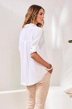 Back view of woman wearing a white Tribal Soft Satin Drop Shoulder Blouse paired with beige patterned pants