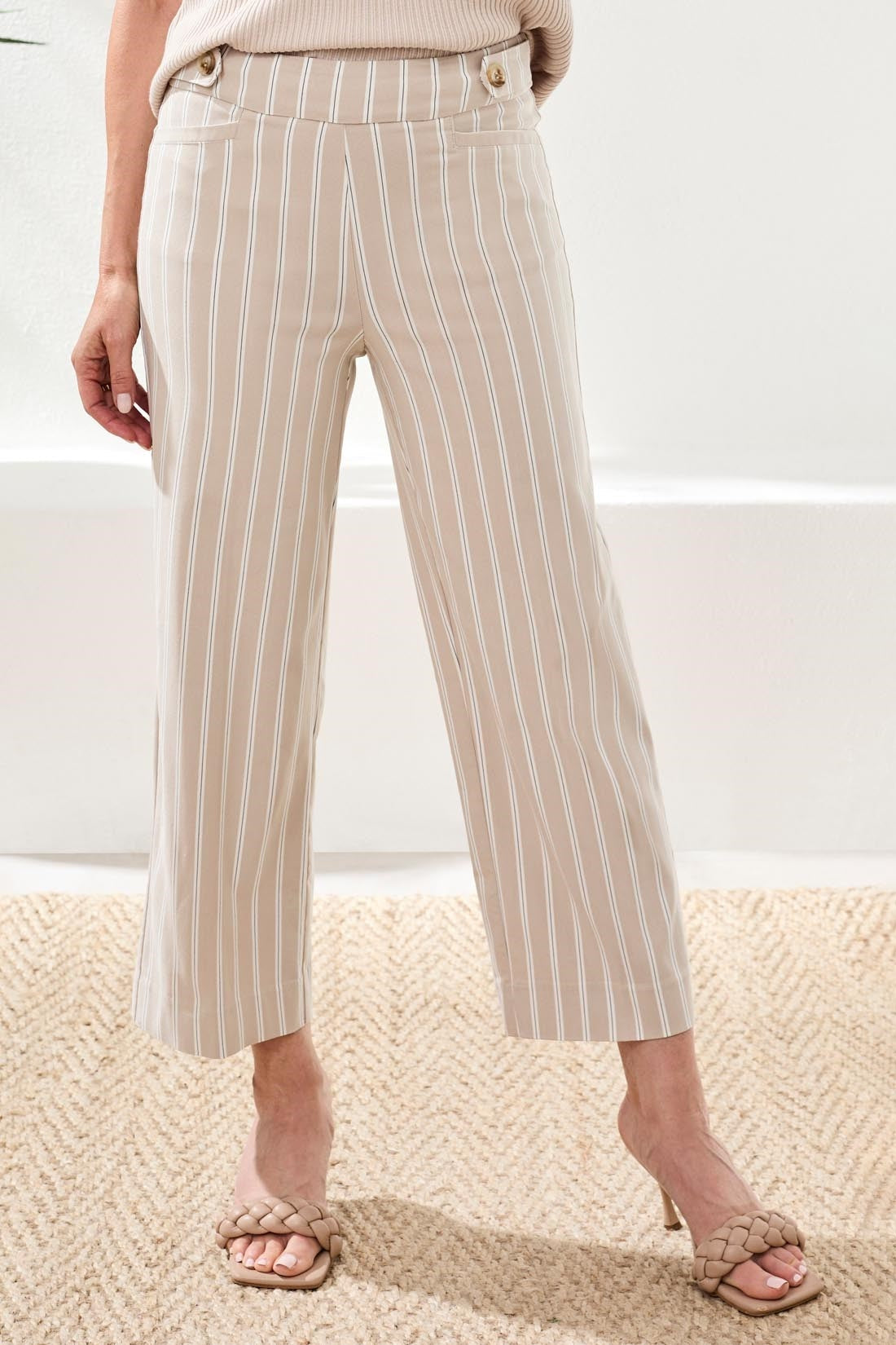 Front view of a woman wearing beige and white striped Tribal Stripe Pull-On Capri Pant by Tribal with button details
