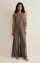 Woman wearing Perfectly Taupe Sloan Jersey Muscle Tank by z supply paired with matching wide-leg pants against neutral background