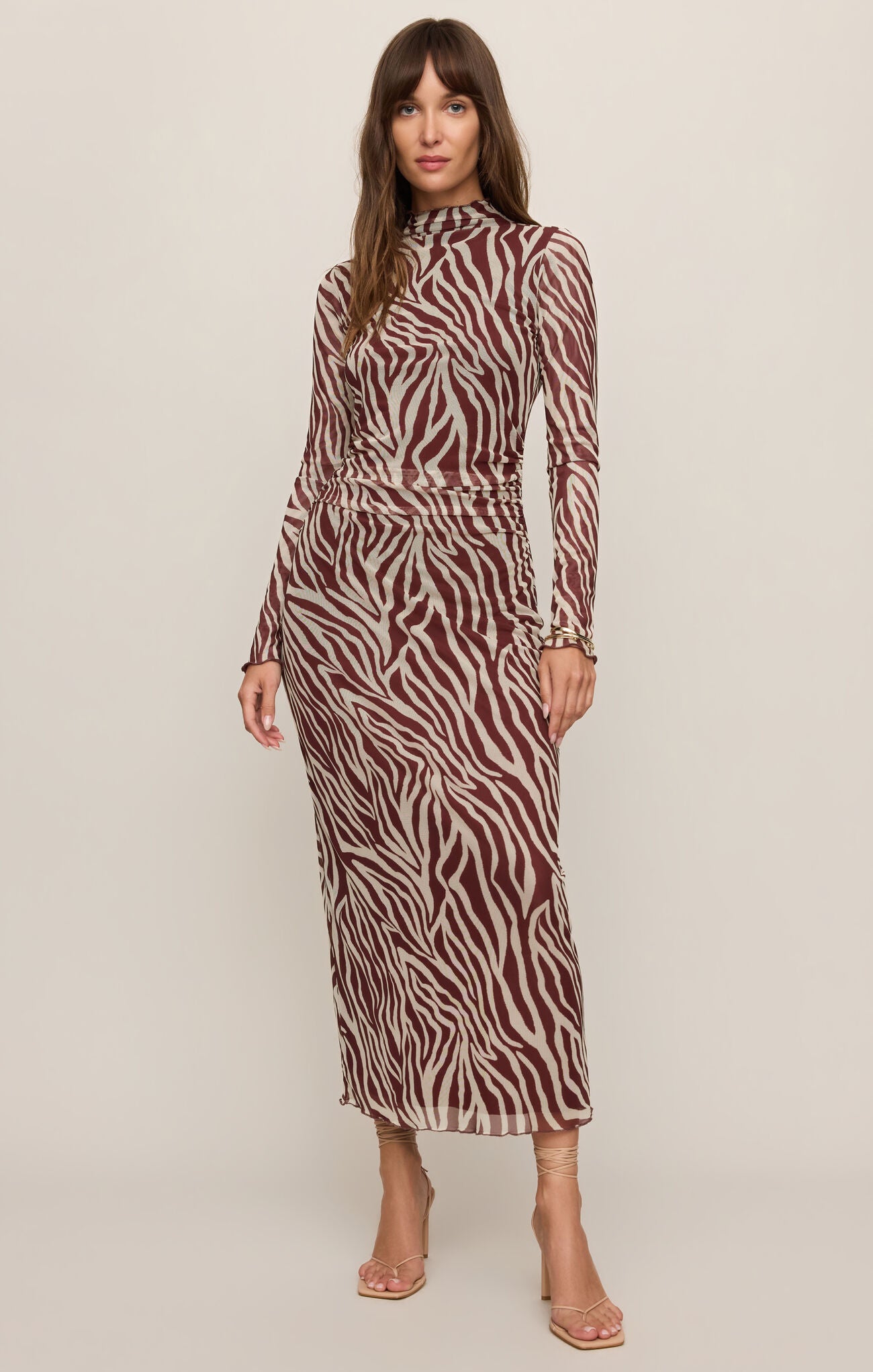 Model wearing a Zebra print Velvet Rouge Sevilla Zebra Mesh Midi Dress by z supply with long sleeves and high neckline