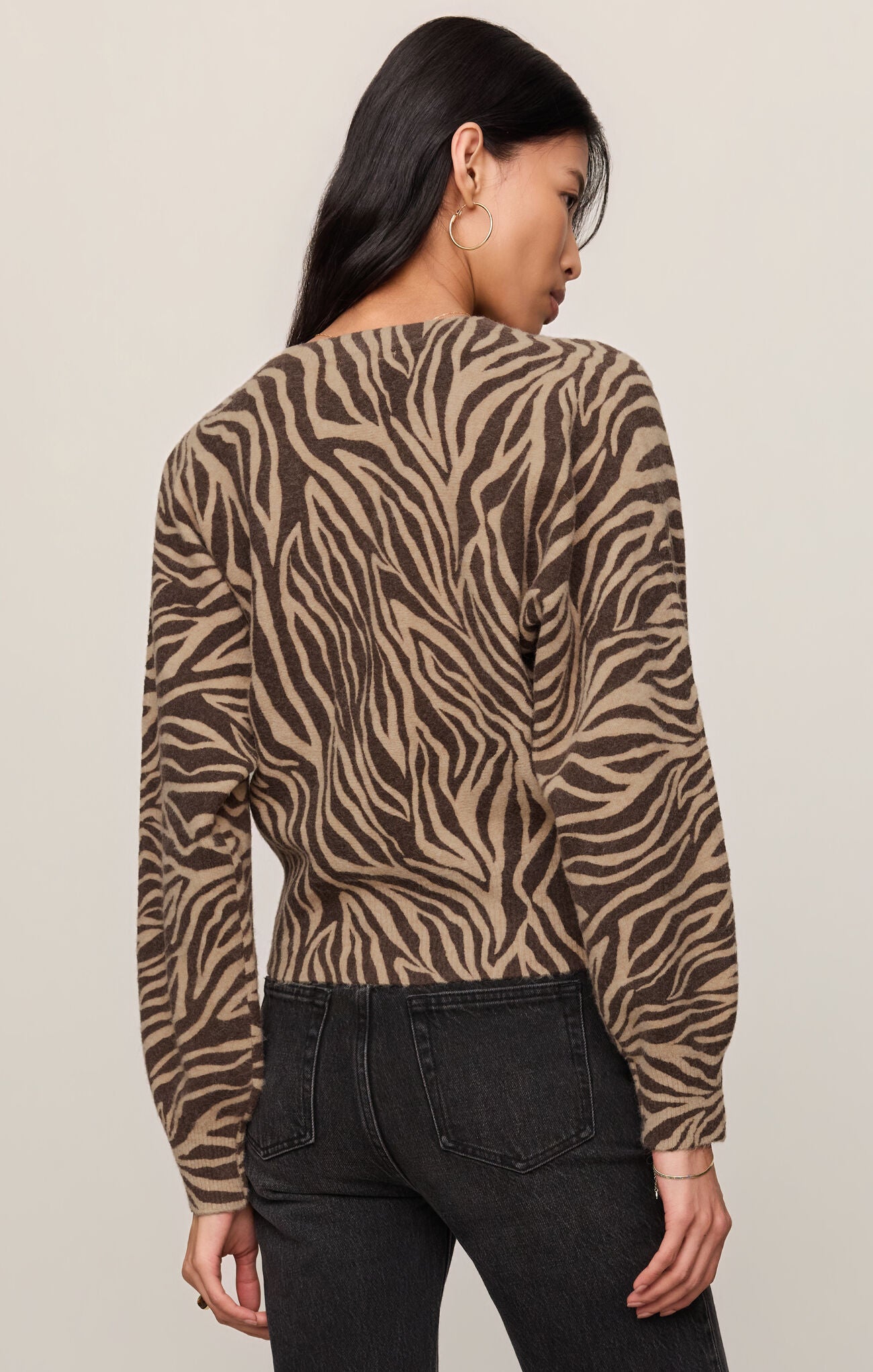 Woman wearing z supply's Dark Chocolate All The Wild Cardigan with animal print pattern viewed from the back