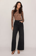 z supply Cocoa Bean Onyx Snake Top in brown snake print with long sleeves styled with black wide leg jeans