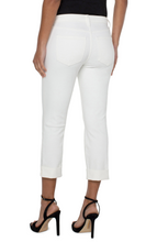 Rear view of a person wearing Bone White Charlie Crop Wide Rolled Cuff 24inch Inseam pants by liverpool with black heels