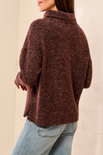 Tribal Hickory Funnel Neck Top in textured brown fabric shown from the back with light wash jeans