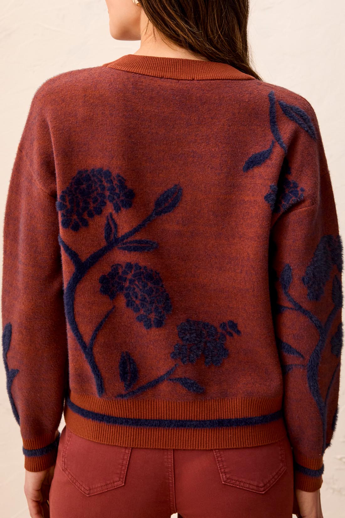 Tribal Sweater by Tribal shown from the back in rust with navy floral pattern and ribbed trim