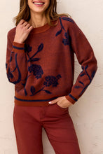 Tribal Sweater by Tribal in rust with navy floral pattern worn by a model