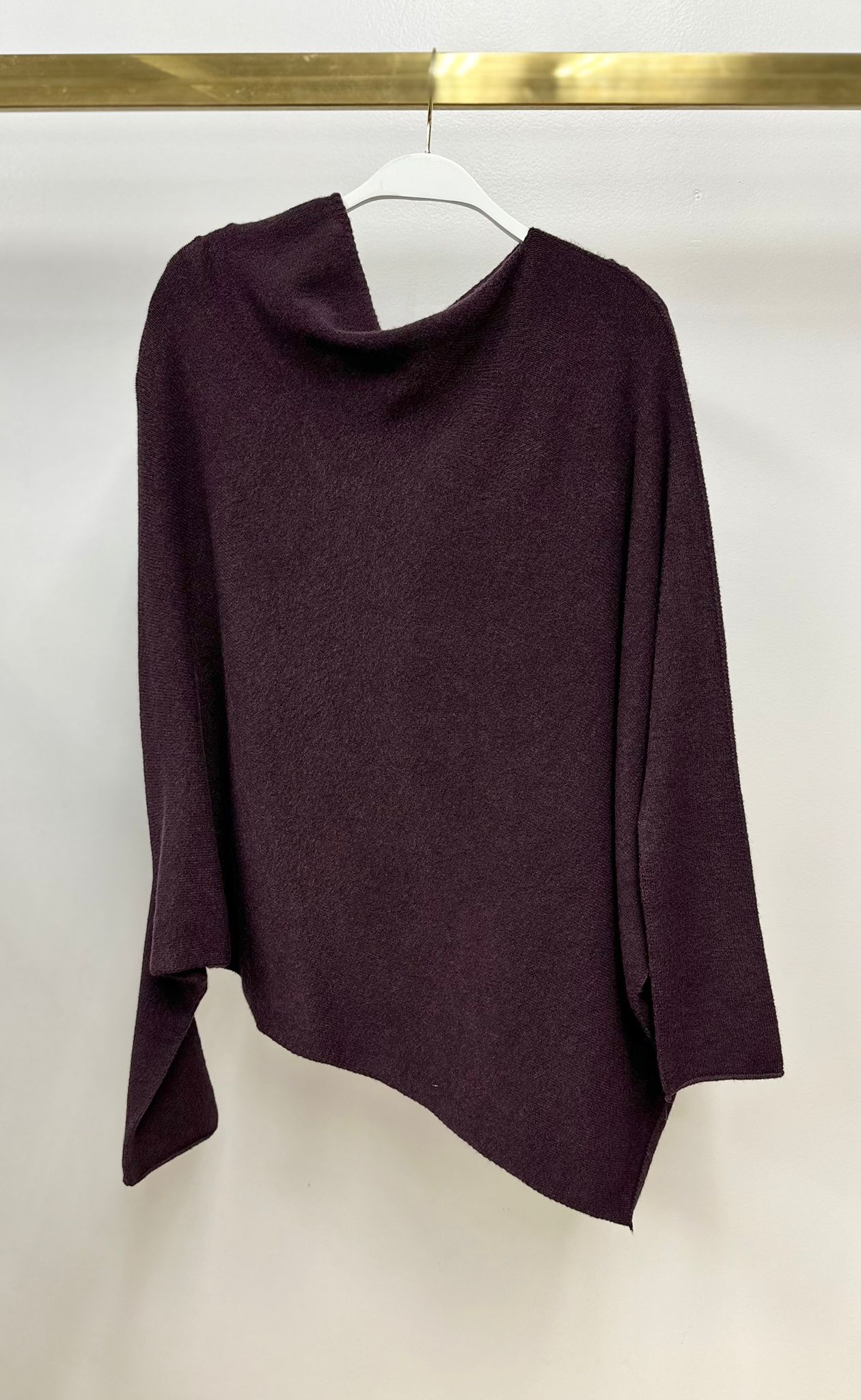 Milio Milano plum asymmetrical knit sweater on a hanger