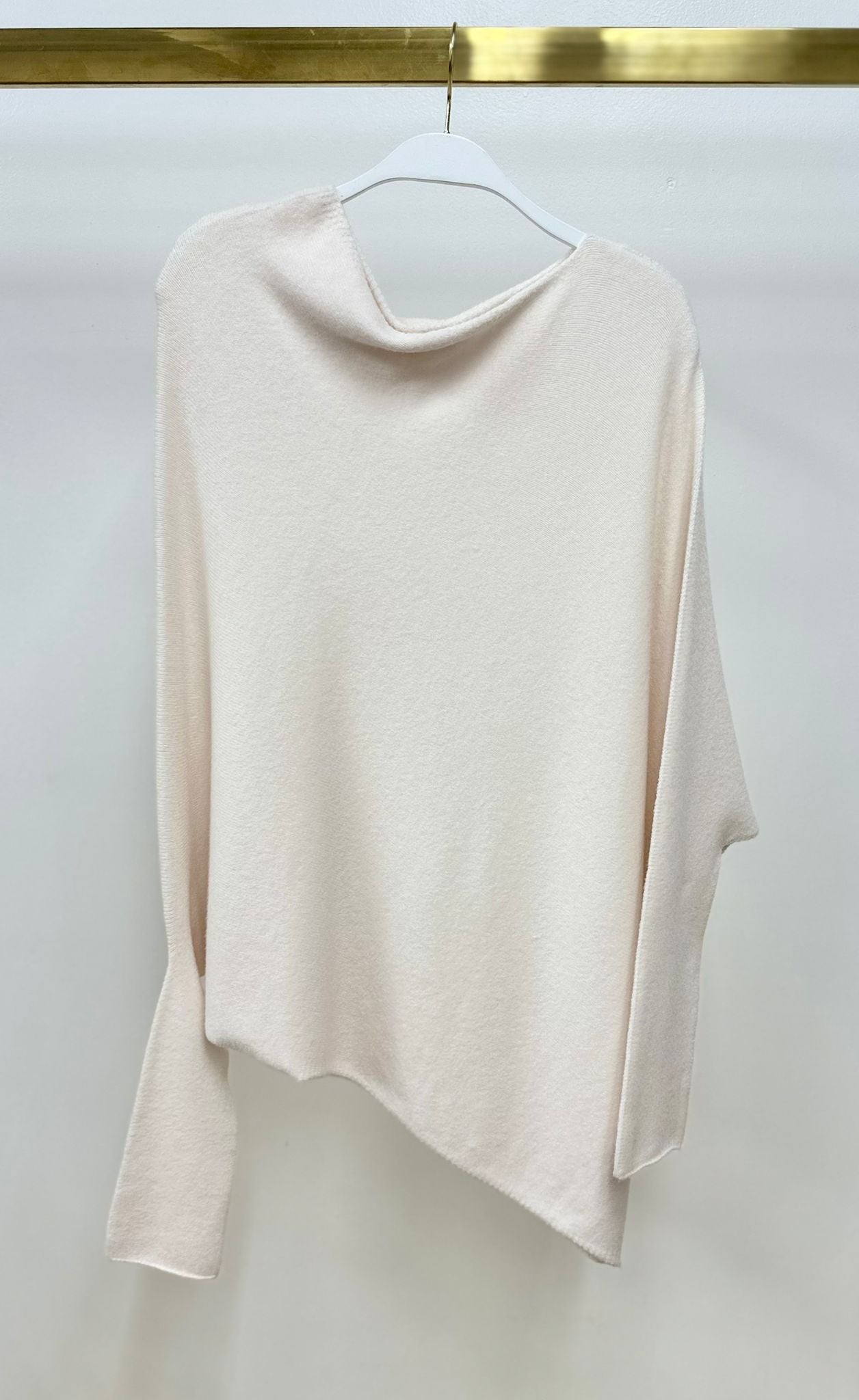 Milio Milano ivory asymmetrical knit sweater on a hanger