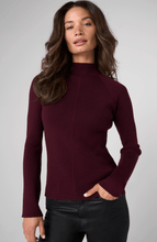 Woman wearing a fitted Oxblood Turtleneck Sweater by liverpool with long sleeves and textured knit design