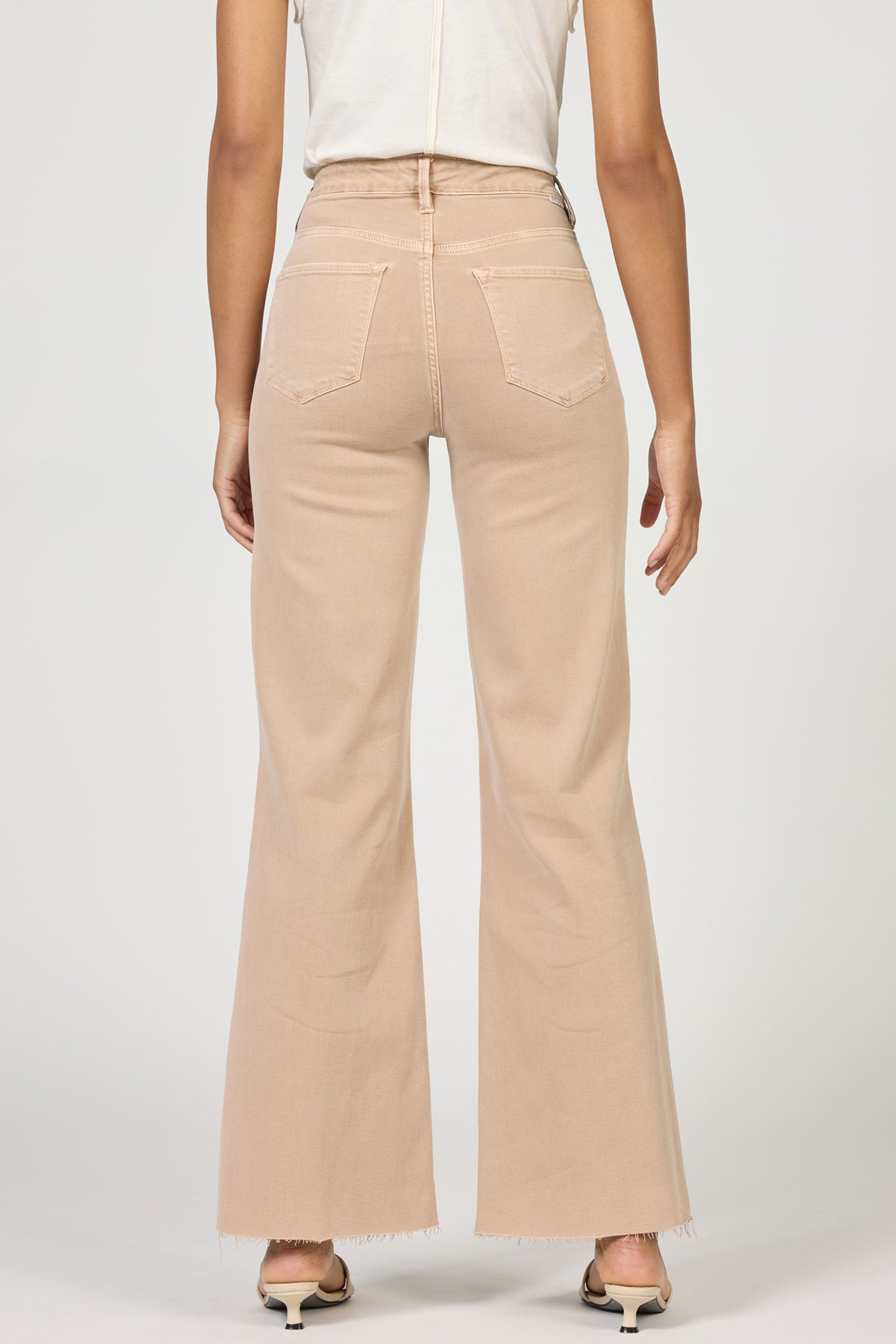 Rear view of a model wearing Fiona Warm Taupe Jeans by dear john in a flattering, versatile warm taupe color