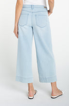 Model wearing light blue wide-leg jeans Marine Flowers Stride Crop Wide Led w/ Embroidered Side Seam by liverpool
