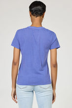 Back view of a person wearing a Pigment Skipper Blue Unity Tee by dear john paired with light blue jeans.