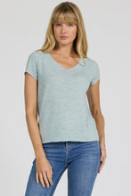 Woman wearing milky blue Aisha Top by dear john with short sleeves and casual fit paired with blue jeans