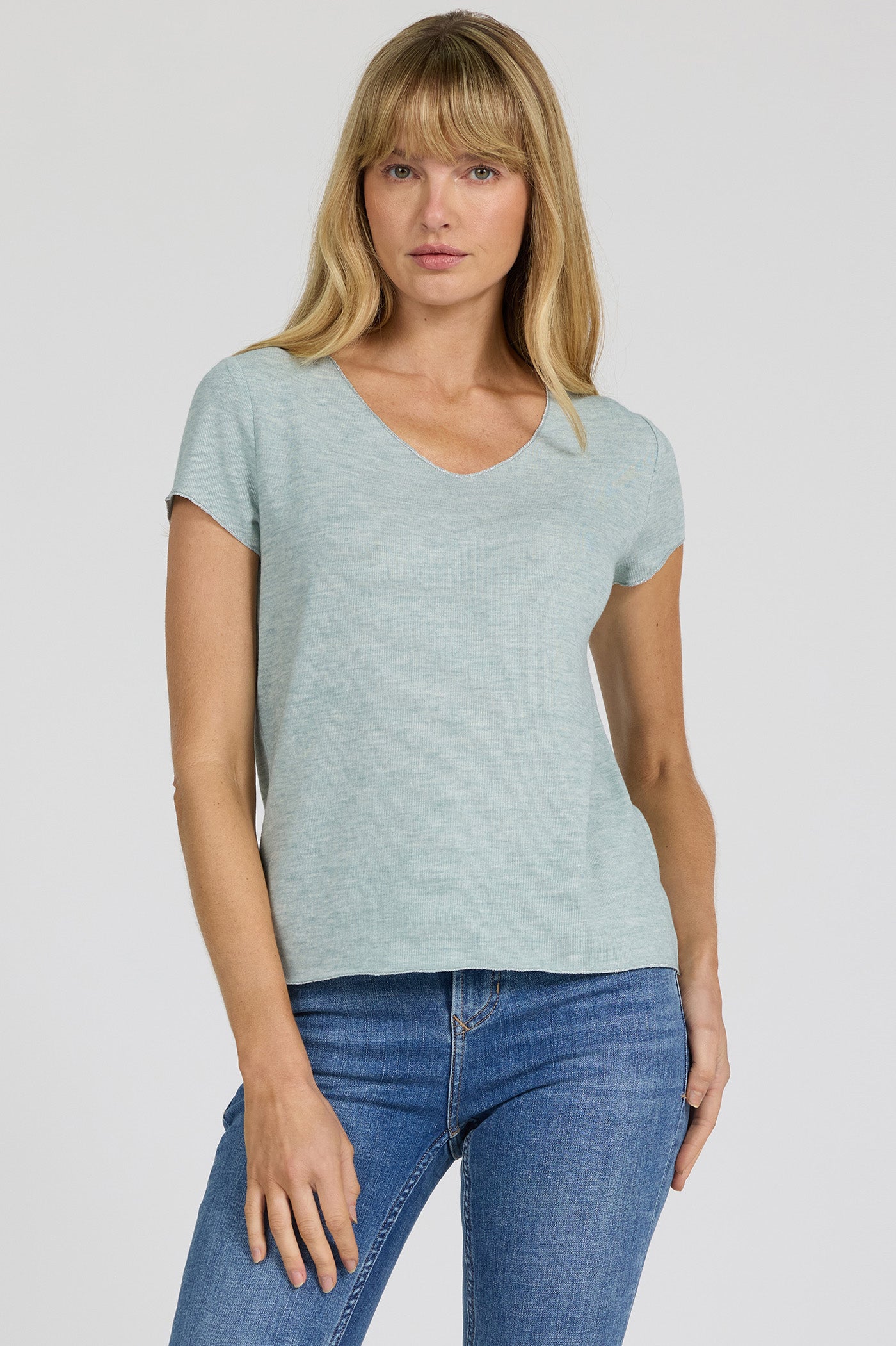 Woman wearing milky blue Aisha Top by dear john with short sleeves and casual fit paired with blue jeans