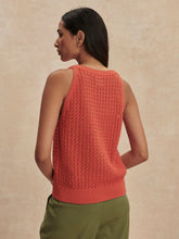 Woman seen from behind wearing a coral Summer Fig Alessia Knit Tank by Varley with green pants against beige background