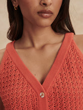 Close-up of a woman wearing a coral Summer Fig Alessia Knit Tank by Varley with textured knit and button detail