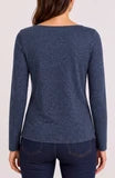 Back view of a person wearing a navy long sleeve top and dark pants