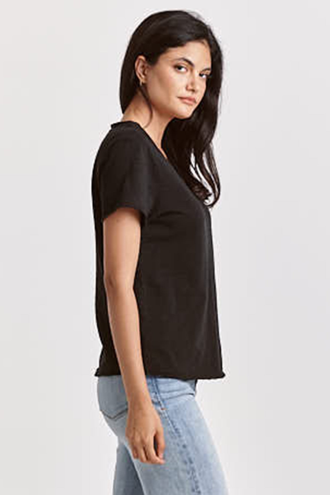 Woman wearing a black Vanya V Neck Tee by dear john, styled with light blue jeans for a relaxed casual look