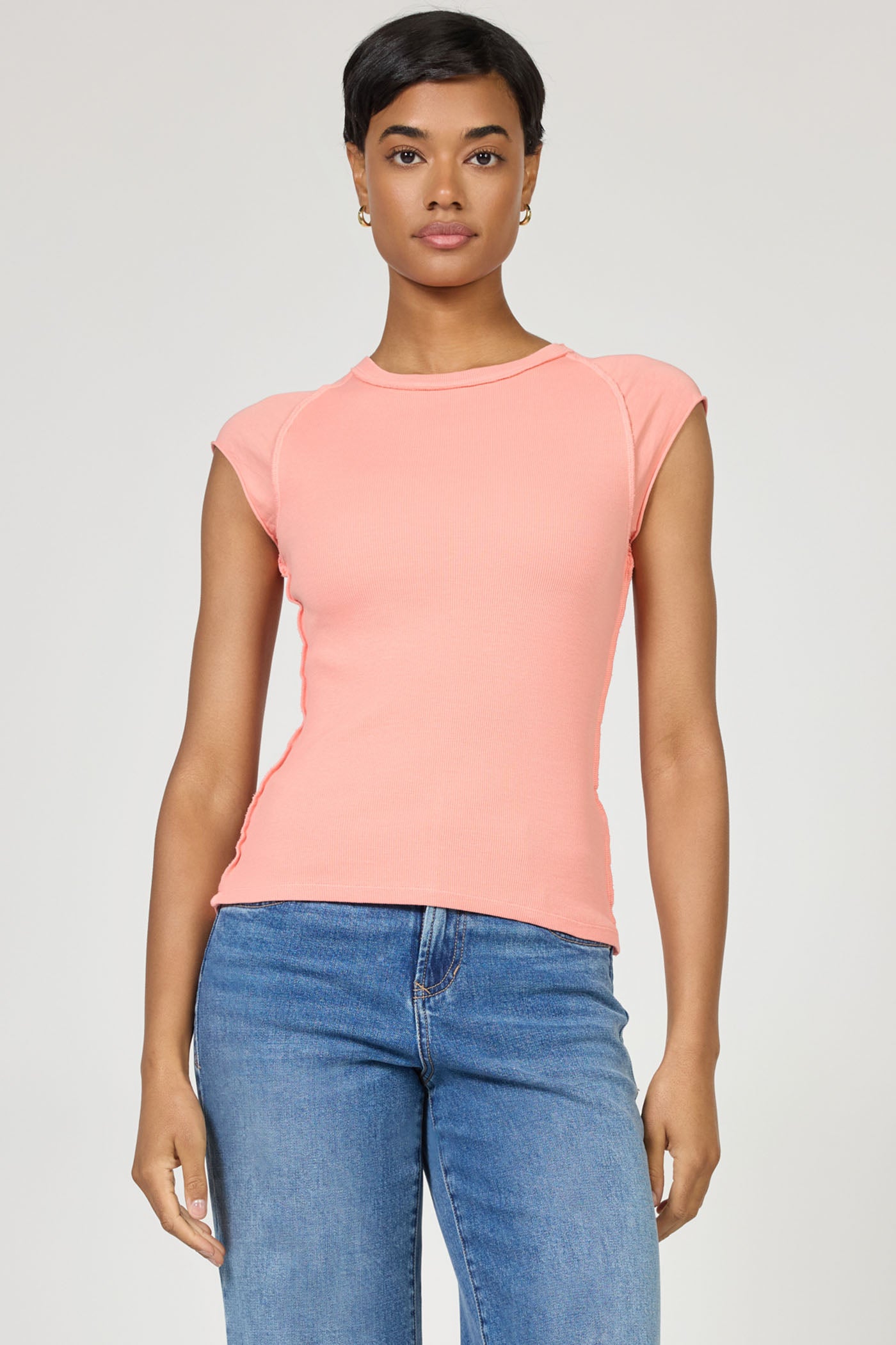 Model wearing the Terracotta Kiyomi Top by dear john in soft terracotta with a minimalist, fitted design and short sleeves