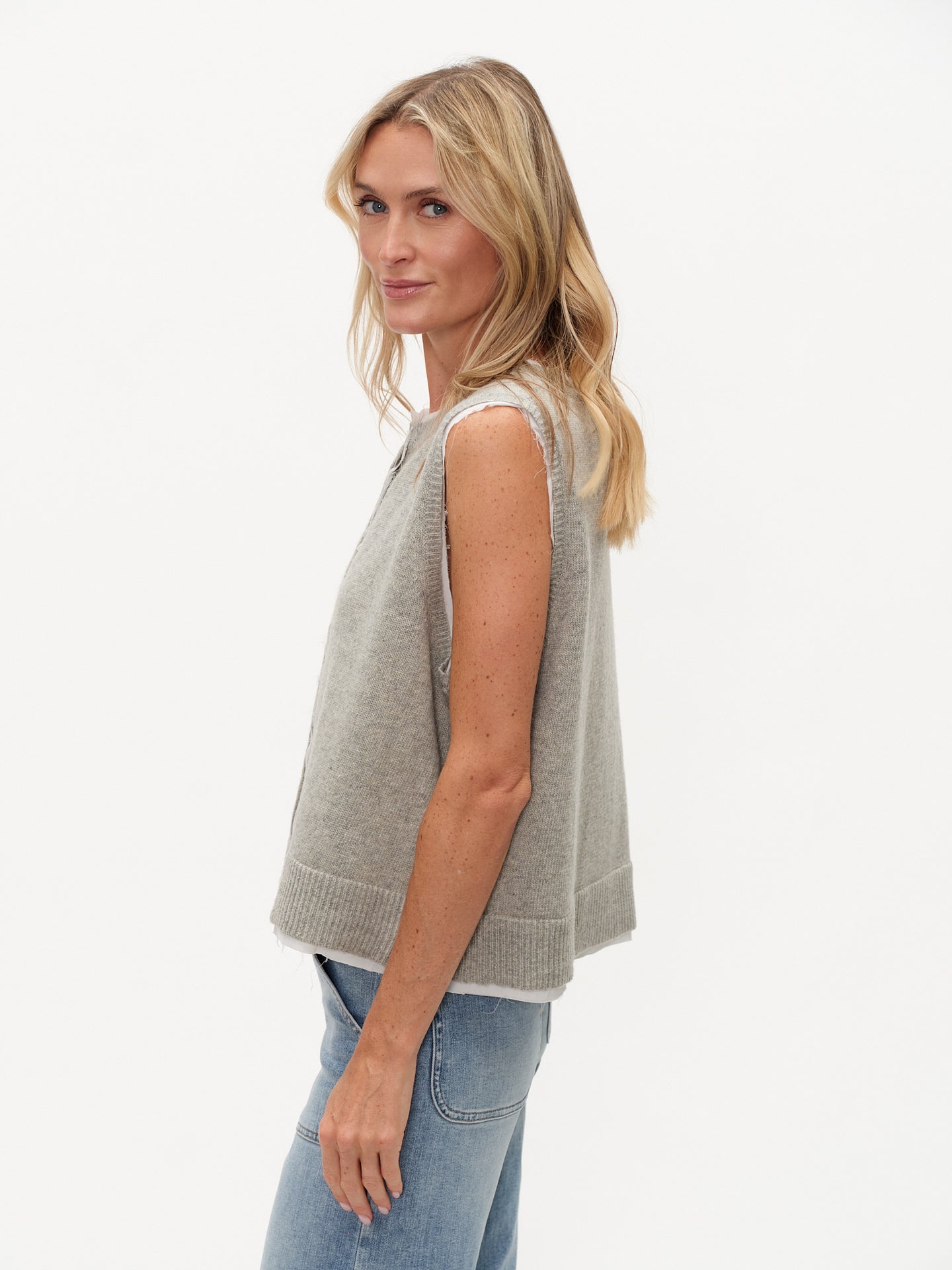 Side view of a woman wearing a Heather Grey Maria Double Layered Vest by six/fifty with clean lines and modern design