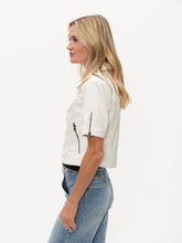 Model wearing the White Monroe Faux Leather SS Collared Jacket by six/fifty in crisp white with short sleeves and zip details
