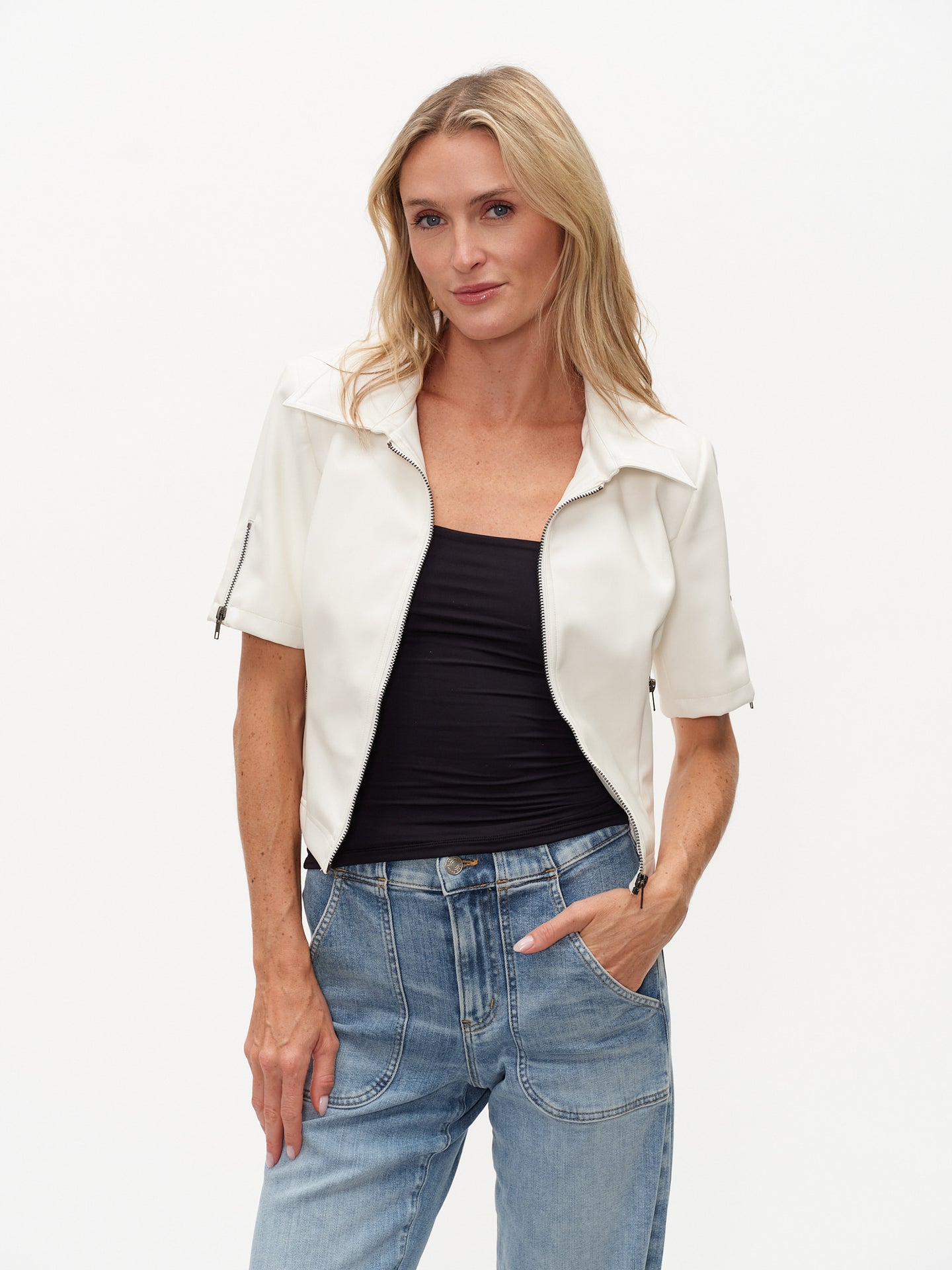 Model wearing White Monroe Faux Leather SS Collared Jacket by six/fifty in white with short sleeves and zip details