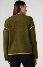 Woman wearing Olive with Mushroom Crewneck Sweater with Cream Tulip Hem, showing back view, paired with black pants