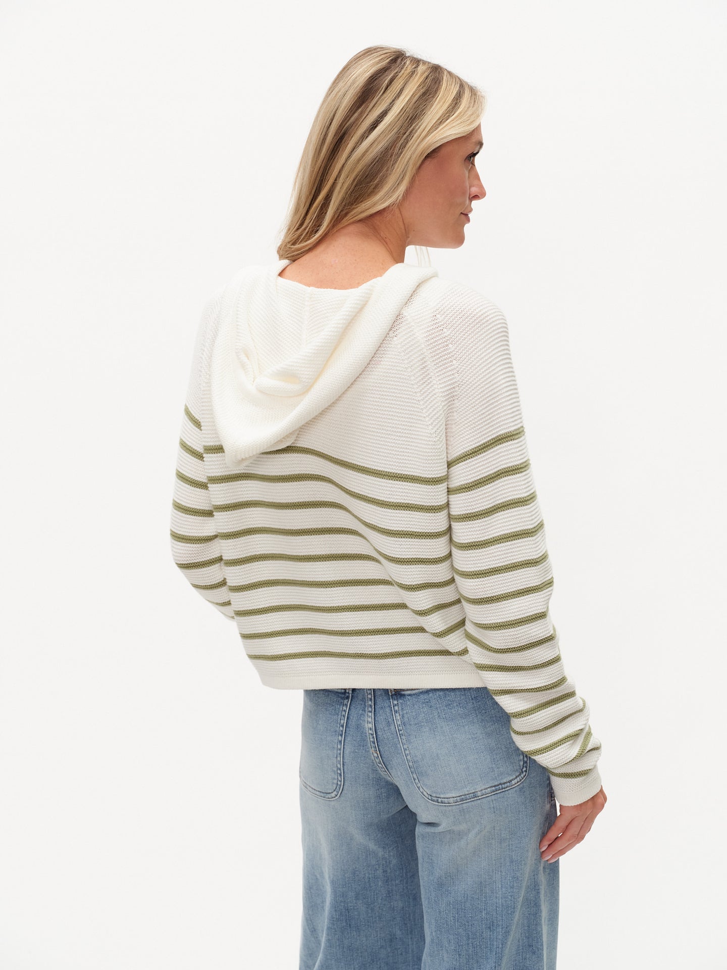 Woman wearing Annalora Striped Button Up Hoodie by six/fifty in white with green stripes, shown from the back